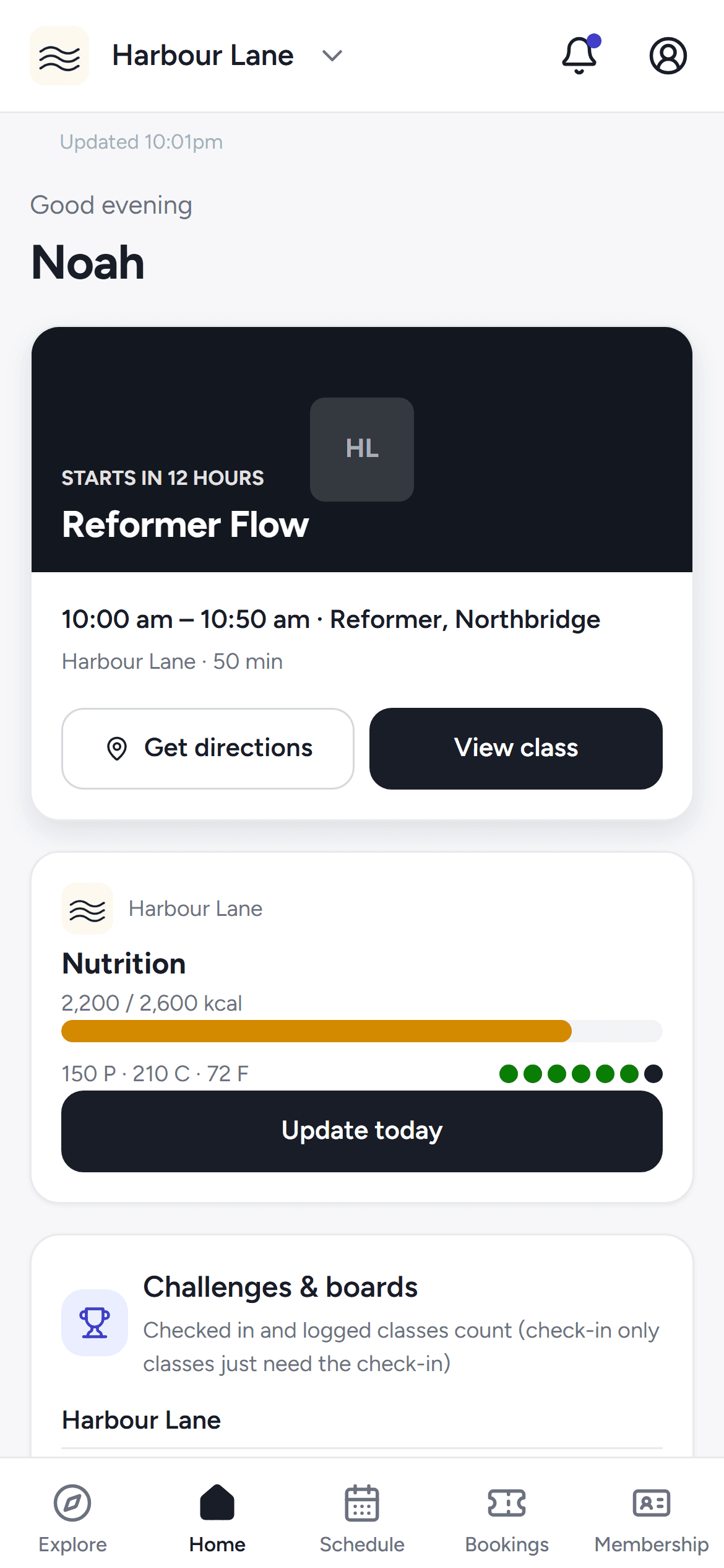The Home tab of the phone app with the member's next class and training streak.